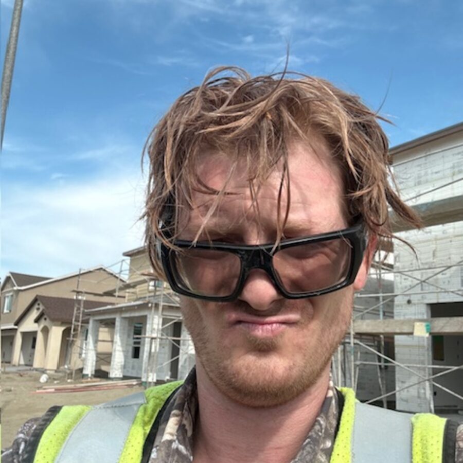 Alex Jay squinting at the camera in safety glasses